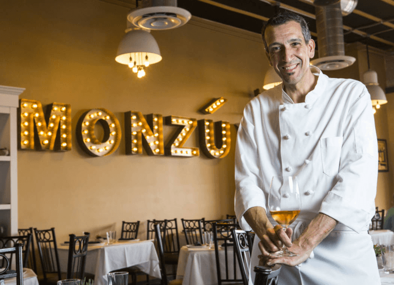 Chef Giovanni Mauro in the Monzú dining room, under the marquee sign